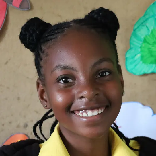 Eine Schülerin aus Südafrika lächelt für das Portrait.