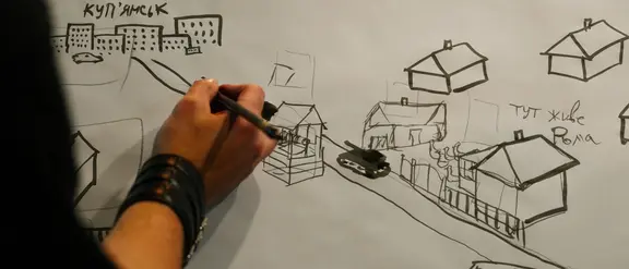 Eine Zeichnung, die eine Straße, Häuser und einen Panzer zeigt