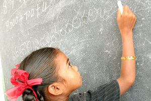 Bildung für Mädchen: Indisches Mädchen schreibt in der Schule an eine Tafel - © terre des hommes